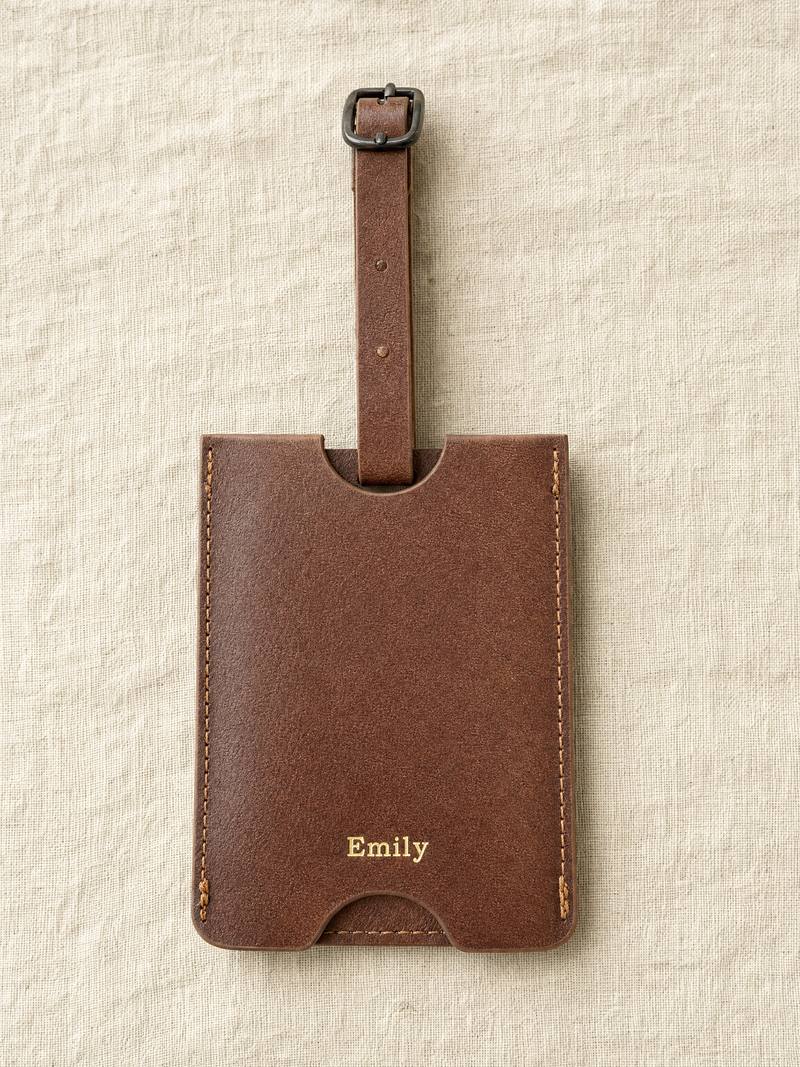 Personalised brown leather luggage tag, the name Emily pressed in gold foil